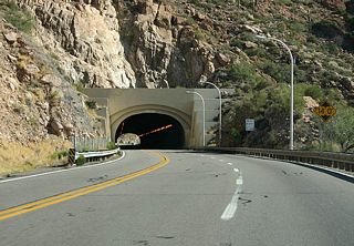 In 1952, the Queen Creek Tunnel was completed. This 1280 foot long tunnel was designed for four traffic lanes, but is currently striped for three. The maximum clearance in the tunnel is 14 feet. This tunnel replaced the shorter 1921 Claypool Tunnel.