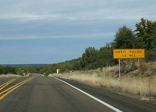 Distance sign to the aforementioned safety pullout, 1/2 mile.