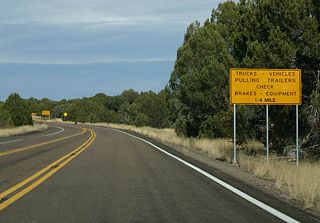 This advisory sign advises trucks and vehicles pulling trailers to check their brakes before heading down into the Salt River Canyon.