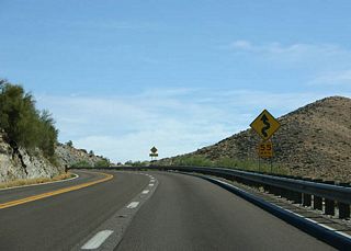 Even with a passing lane, US 60 snakes along the canyon 
wall, limiting the utility of the passing lane. US 60 
is climbing eastbound as it approaches Superior.