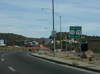 The next road junction US 60 meets is US 70 and SR 77, in 1/2 mile.