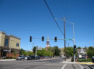 Signs posted on Orange Street north at Broadway Street omit shields for Business Loop I-90 and instead direct motorists northward for the continuation of U.S. 93 Business. Since 2006, the shield assembly pictured here was removed and a new U.S. 93 (without a business banner) assembly was added to the utility pole beyond the Broadway Street mast-arm signal.